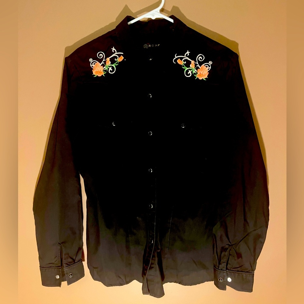 Black shirt with pink rose embroidery.
